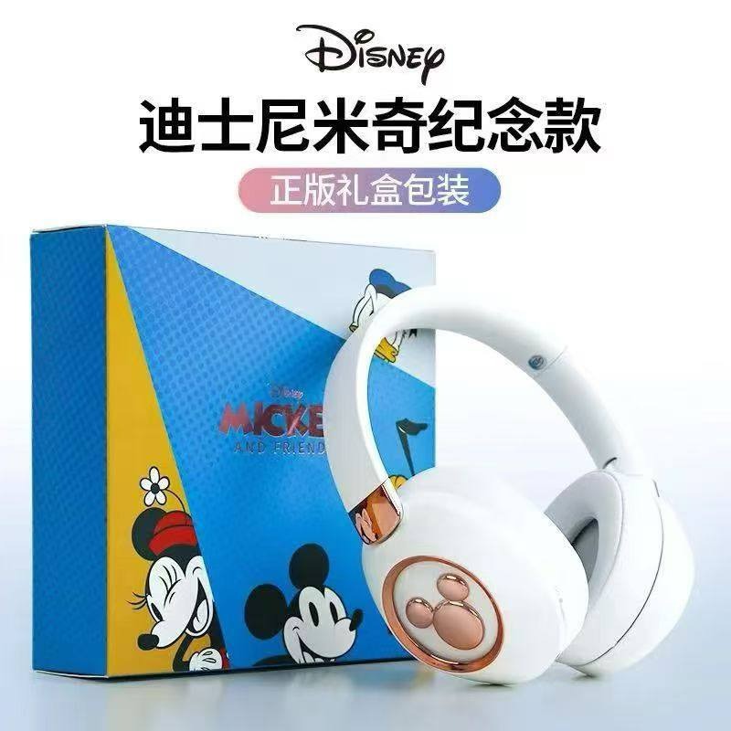 White headphones with a Disney character design on a blue box featuring Mickey Mouse, with Disney branding above.